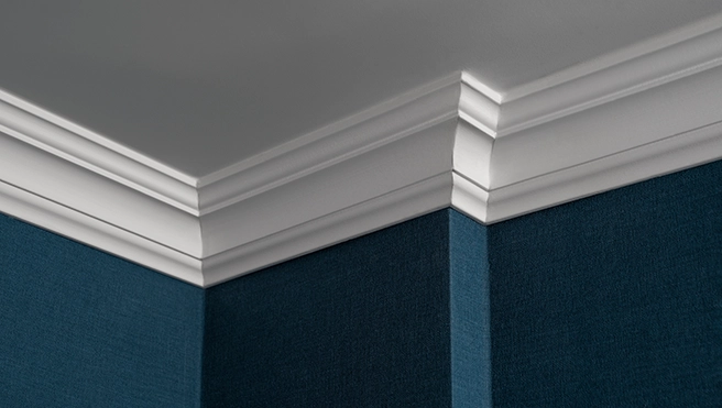 Close-up of a textured blue wall meeting a ceiling.