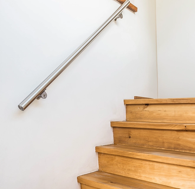 Wooden staircase with steel handle.