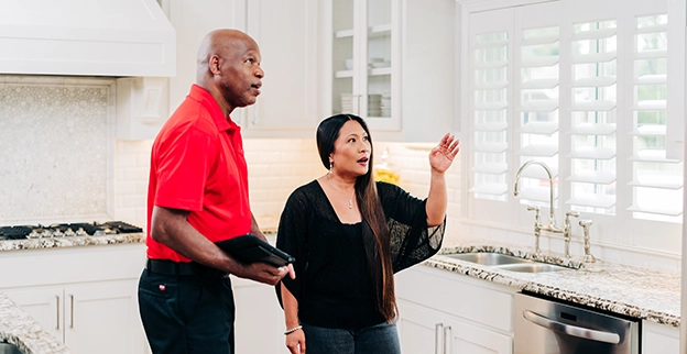 Mr Handyman talking to a client.