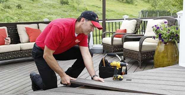 Mr. Handyman service professional performing patio repairs.
