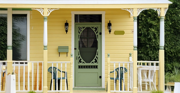 Yellow house with a green front door.