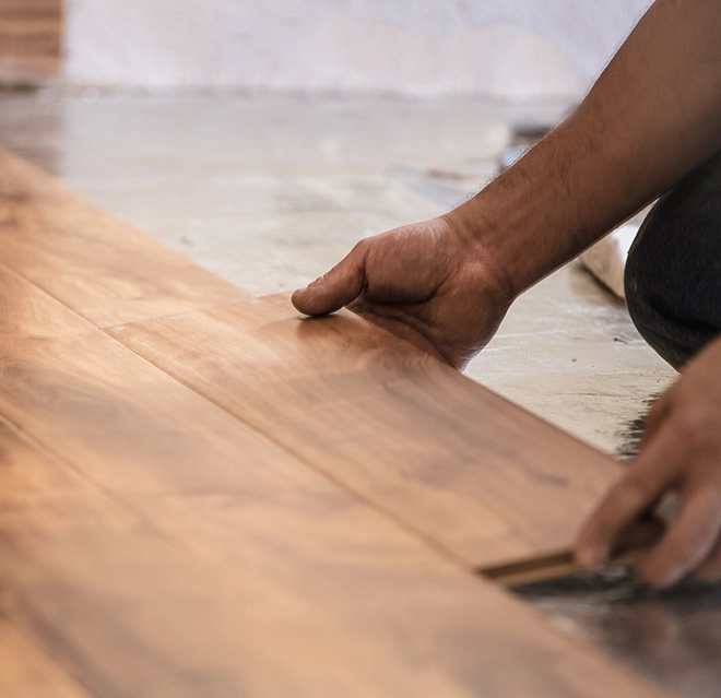 A wooden floor plank on a smooth surface.