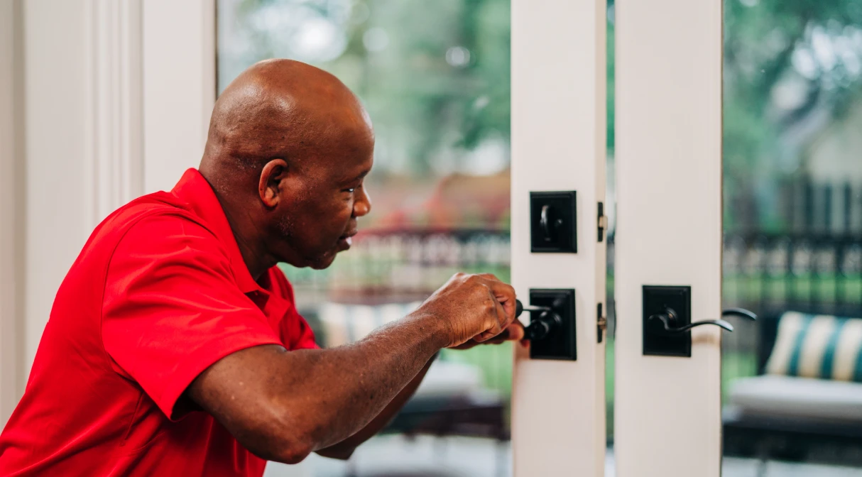 handyman fixing patio door lock