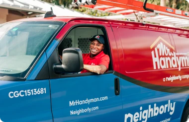 A Mr. Handyman service professional in a work van.