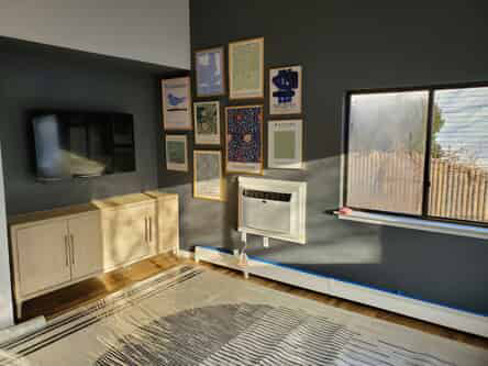 Living room with tv, framed pictures, and a window.
