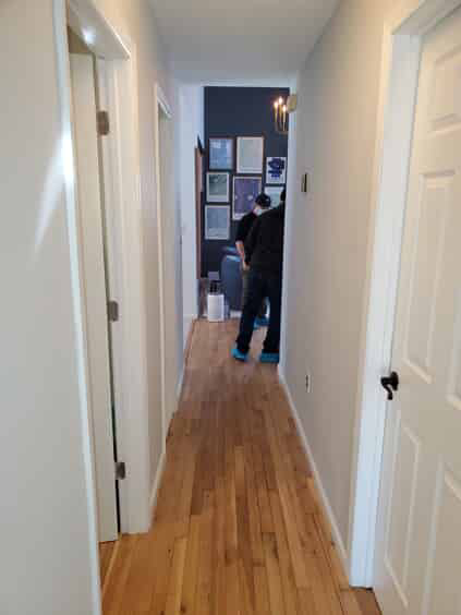 White hallway with wooden floors