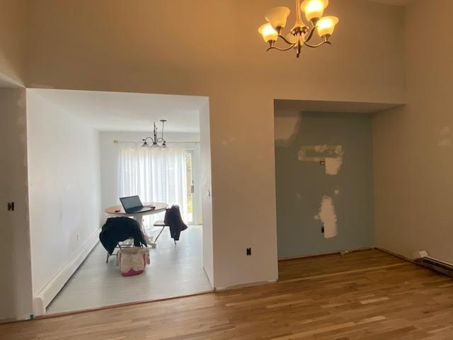 Dining room with half finished wall and a small dining table