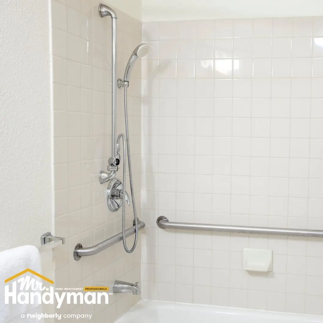 Bathroom shower with securely installed stainless steel grab bars and handheld shower mounted by Mr. Handyman of Bethlehem