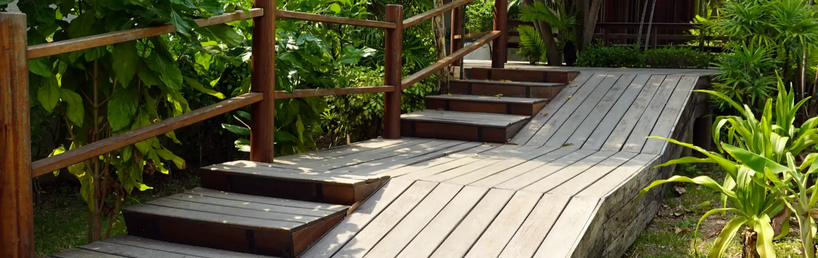 A wooden wheelchair ramp next to stairs