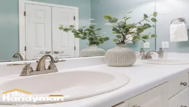 Modern white double-sink bathroom vanity with black hardware and round mirrors installed by Mr. Handyman of Bethlehem and Allentown