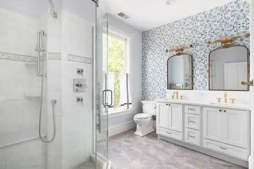 Modern bathroom remodel with updated gold fixtures and layout