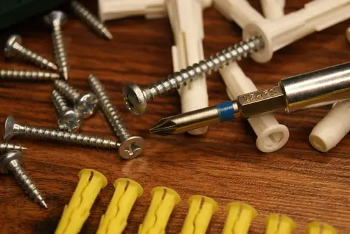 Drywall anchors and screws with a drill bit.