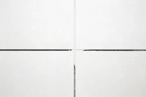 Tiles with paste during grout repair.