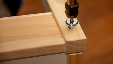 Professional handyman providing IKEA furniture assembly service with tools.