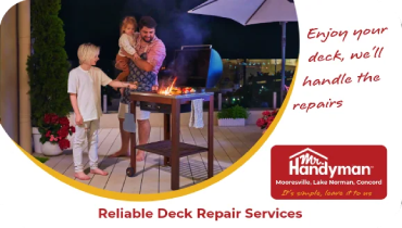 Family grilling together on a backyard deck at night.