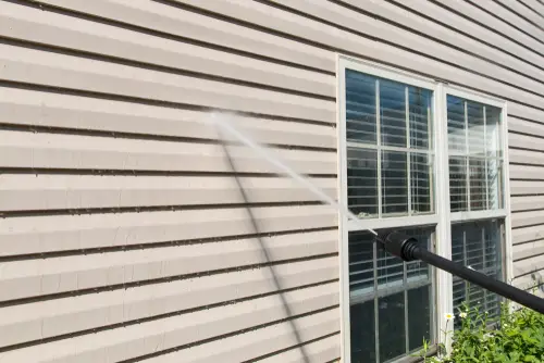 Power washing vinyl exterior residential siding.