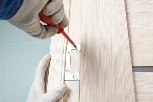 Professional handyman replacing an interior door