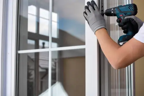 Professional window repair services fixing a damaged window frame and screen.