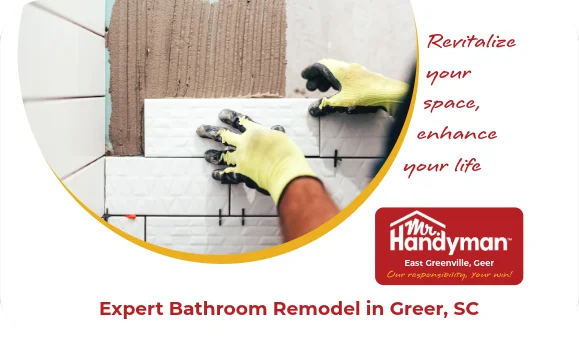 Worker installing white ceramic wall tiles.