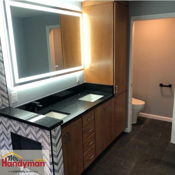 Updated bathroom vanity with LED mirror lighting and wide-access flooring in Citrus Park, installed by Mr. Handyman for senior safety.