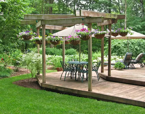 Outdoor floating deck with elaborate green furniture.