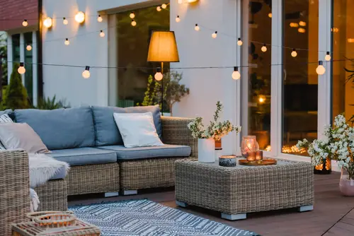 Strings of lights around an outdoor patio on a summer evening