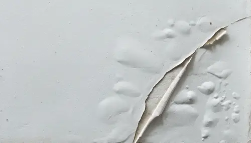Peeling paint caused by moisture damage in need of house painting services.