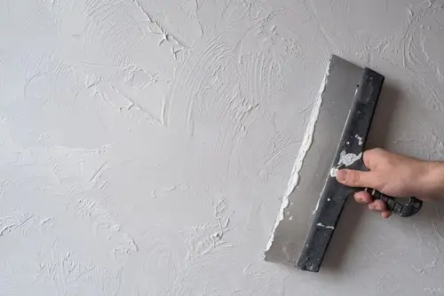 Applying stucco with texture.