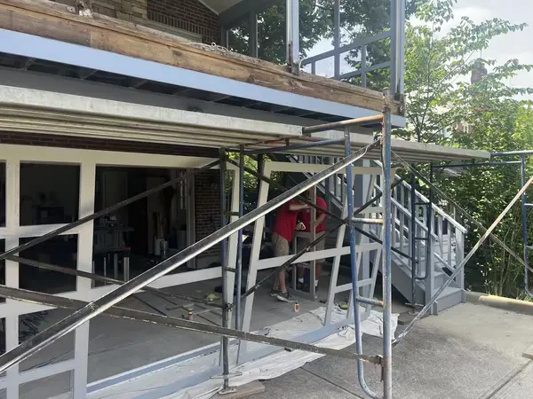 Mr. Handyman of Greater Cincinnati professionals working on a major wood rot repair for a deck.