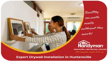 Young woman decorating a room after having the drywall fixed.