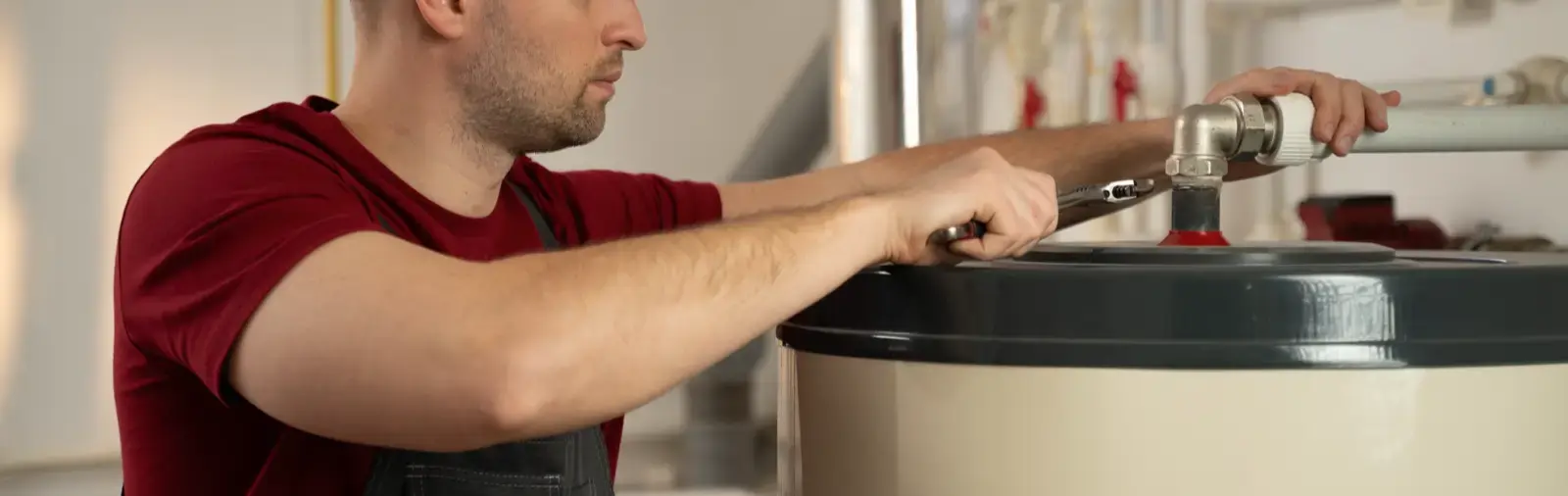 A service professional works on installing a water heater.