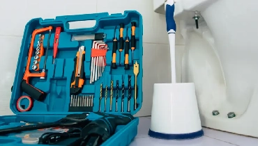 Open toolbox next to base of toilet.
