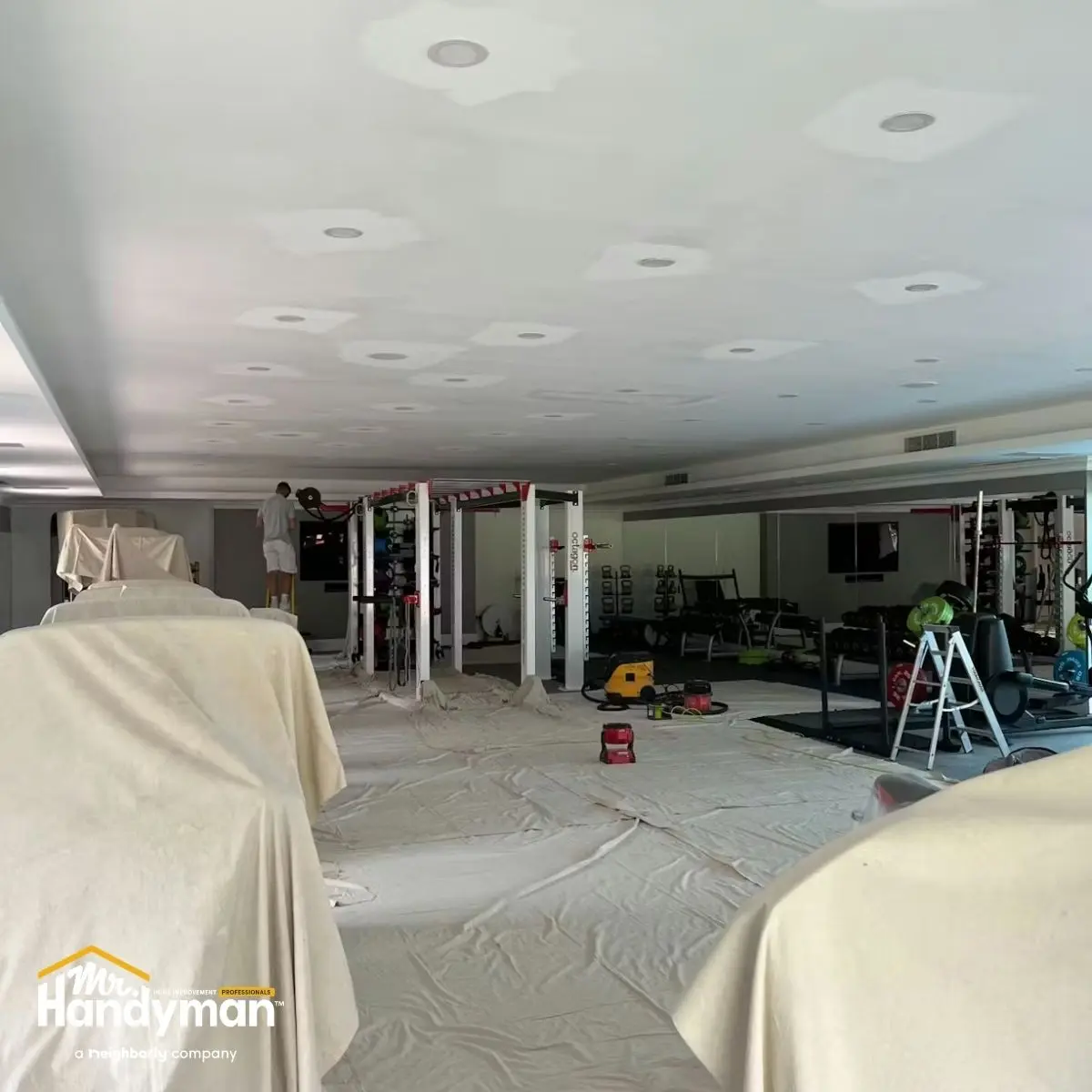 Gym under renovation with equipment covered.