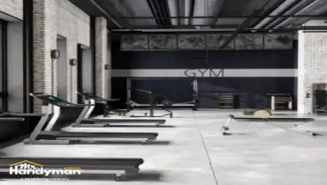 handyman repairing commercial gym entry door and lock in Nashville TN.