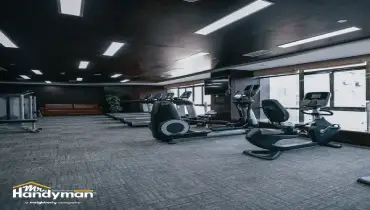 Technician assembling commercial gym equipment in Charleston SC fitness facility.