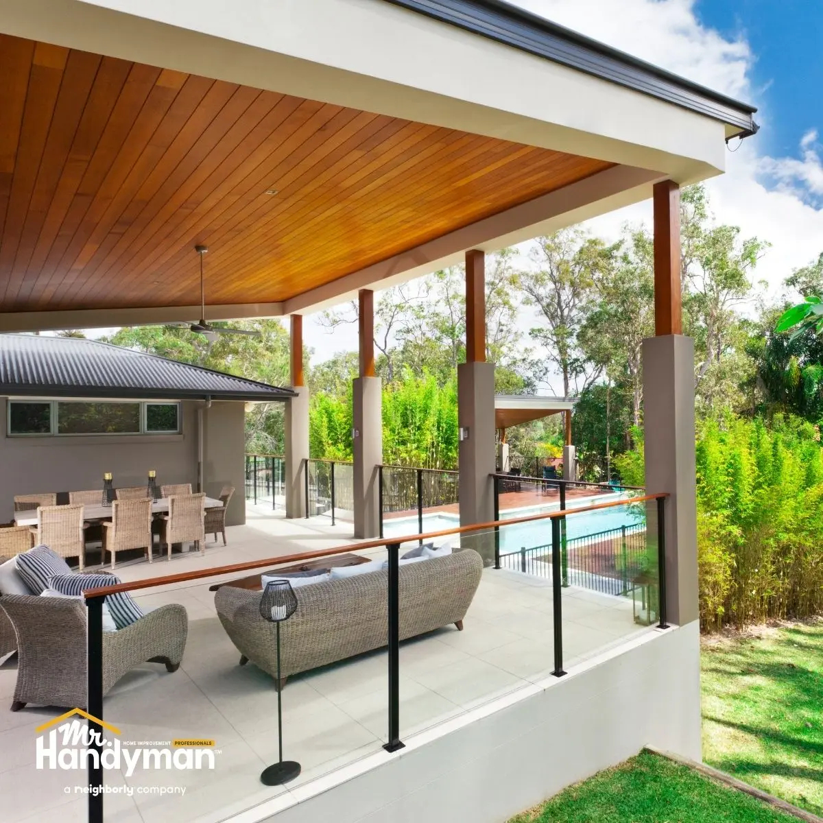 Modern outdoor patio with wicker furniture under a wood-paneled ceiling.