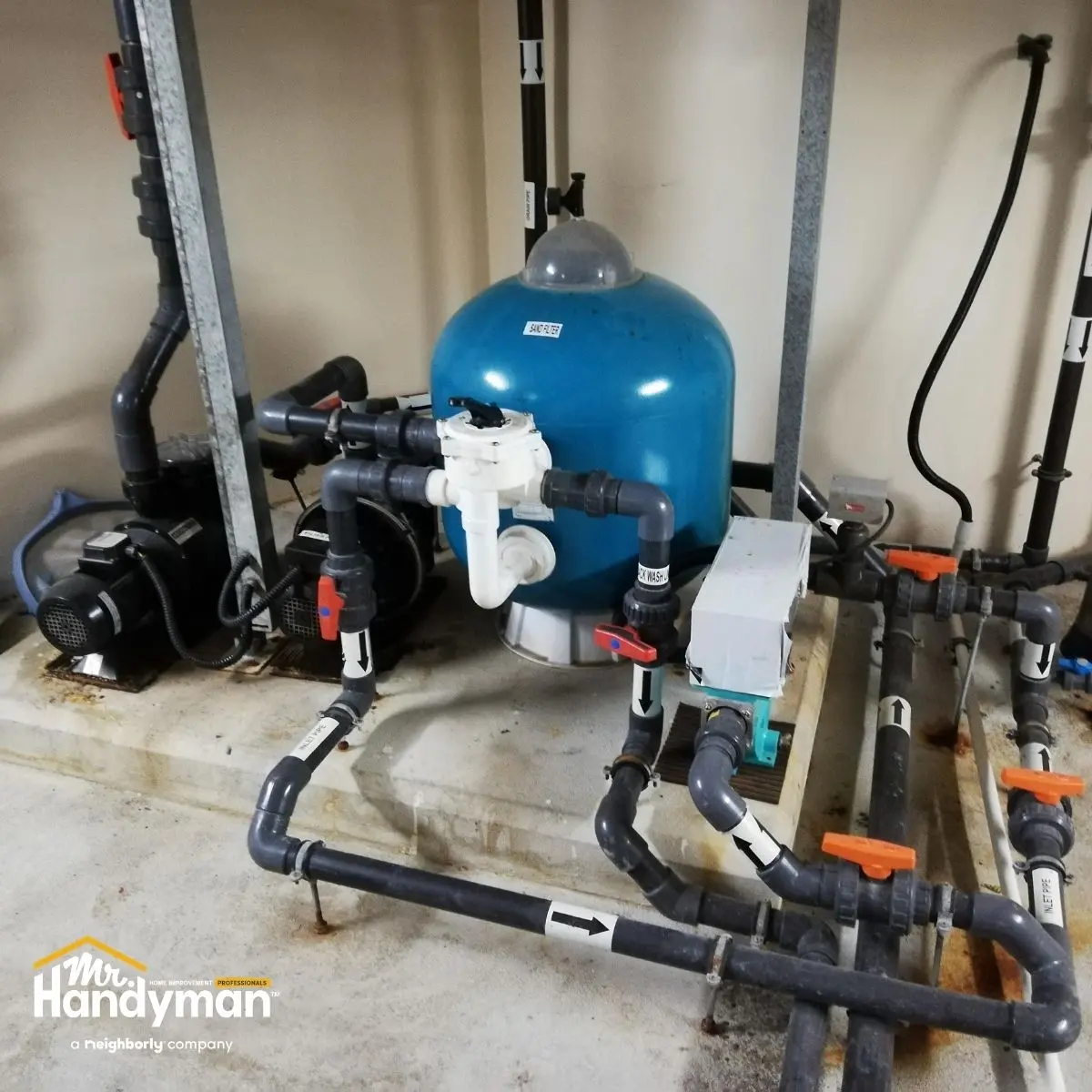 blue water filtration tank with connected black and gray pipes 