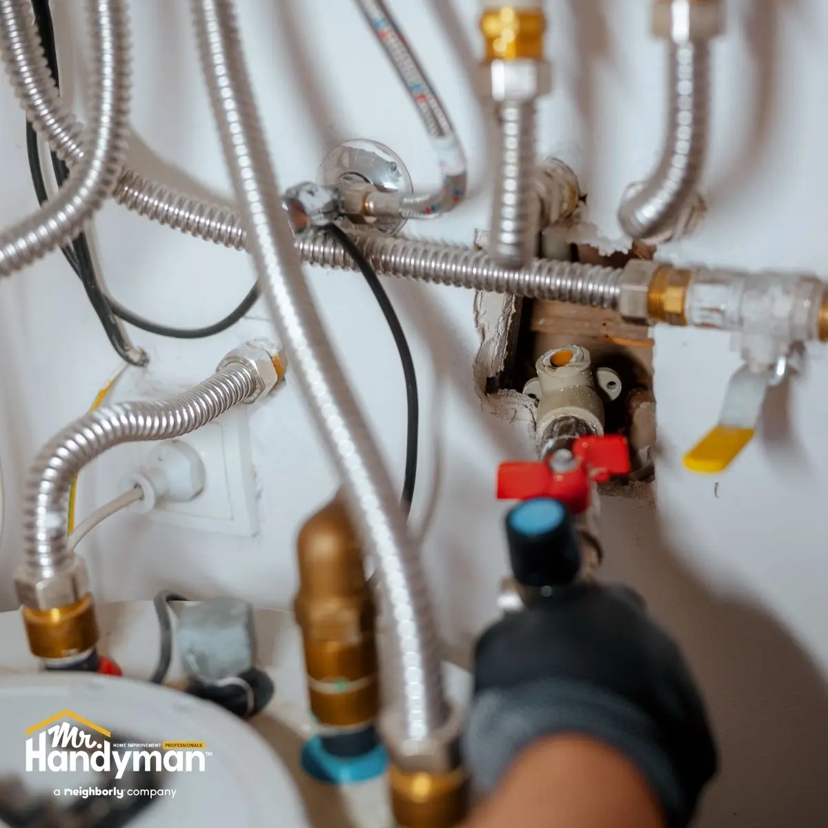 a close-up of a handyman adjusting plumbing pipes with a wrench.