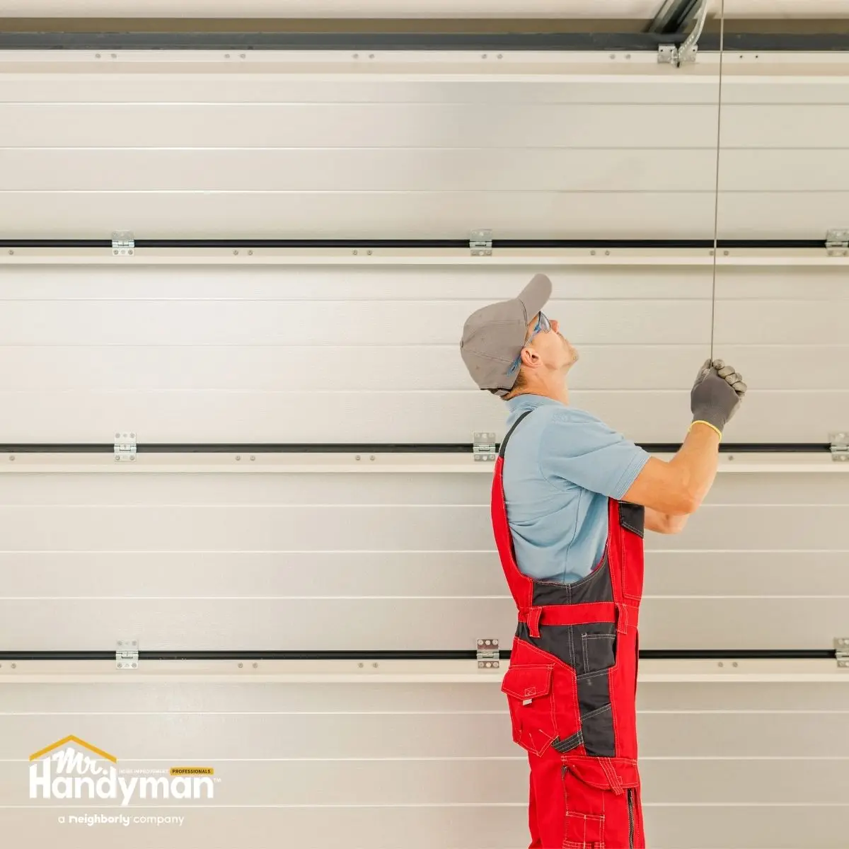 A handyman pulls a cable.