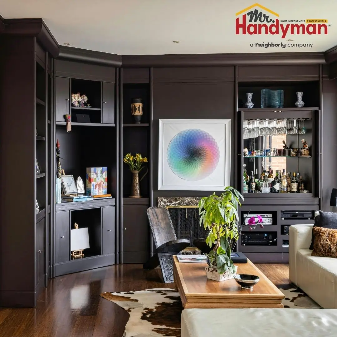 Handyman installing custom built-in shelving in a living room in Martinsburg West Virginia.
