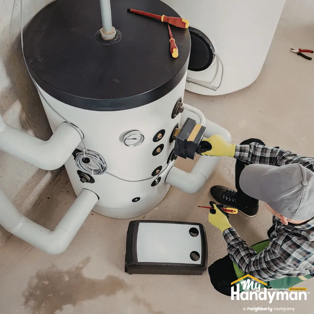 Technician repairs a large heating system with tools.