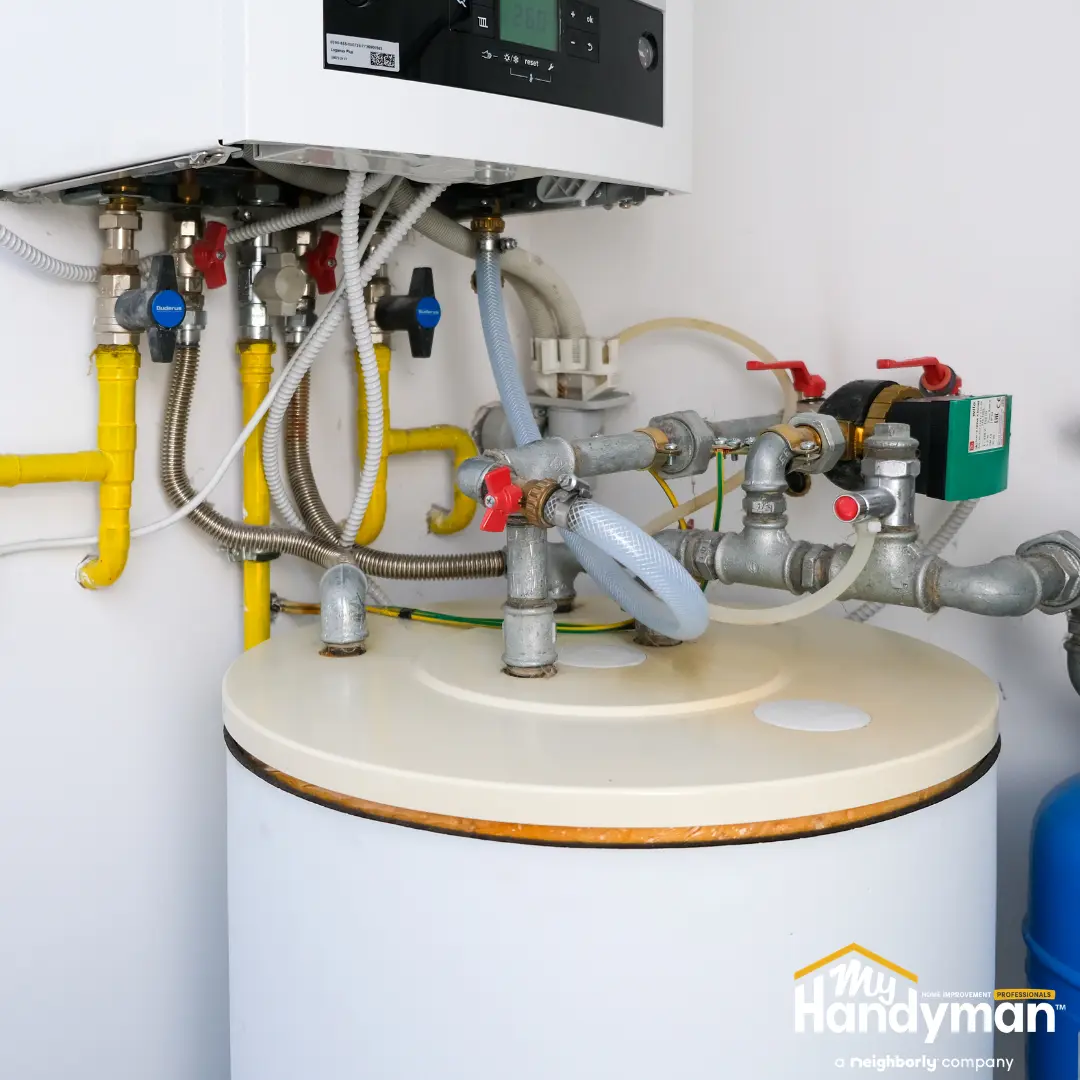 Close-up of plumbing connections and water heater system.