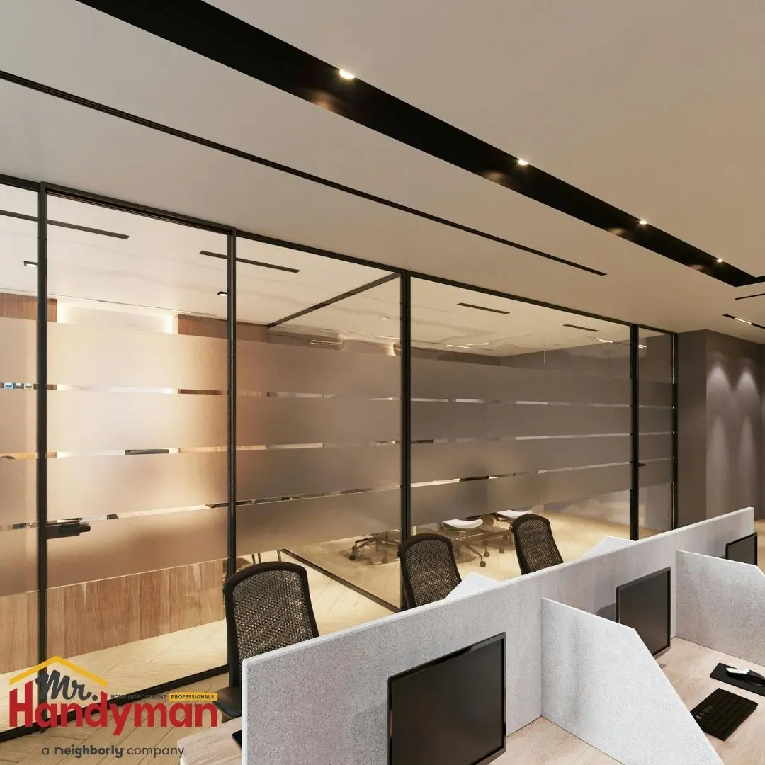 A large office space with a row of cubicles.