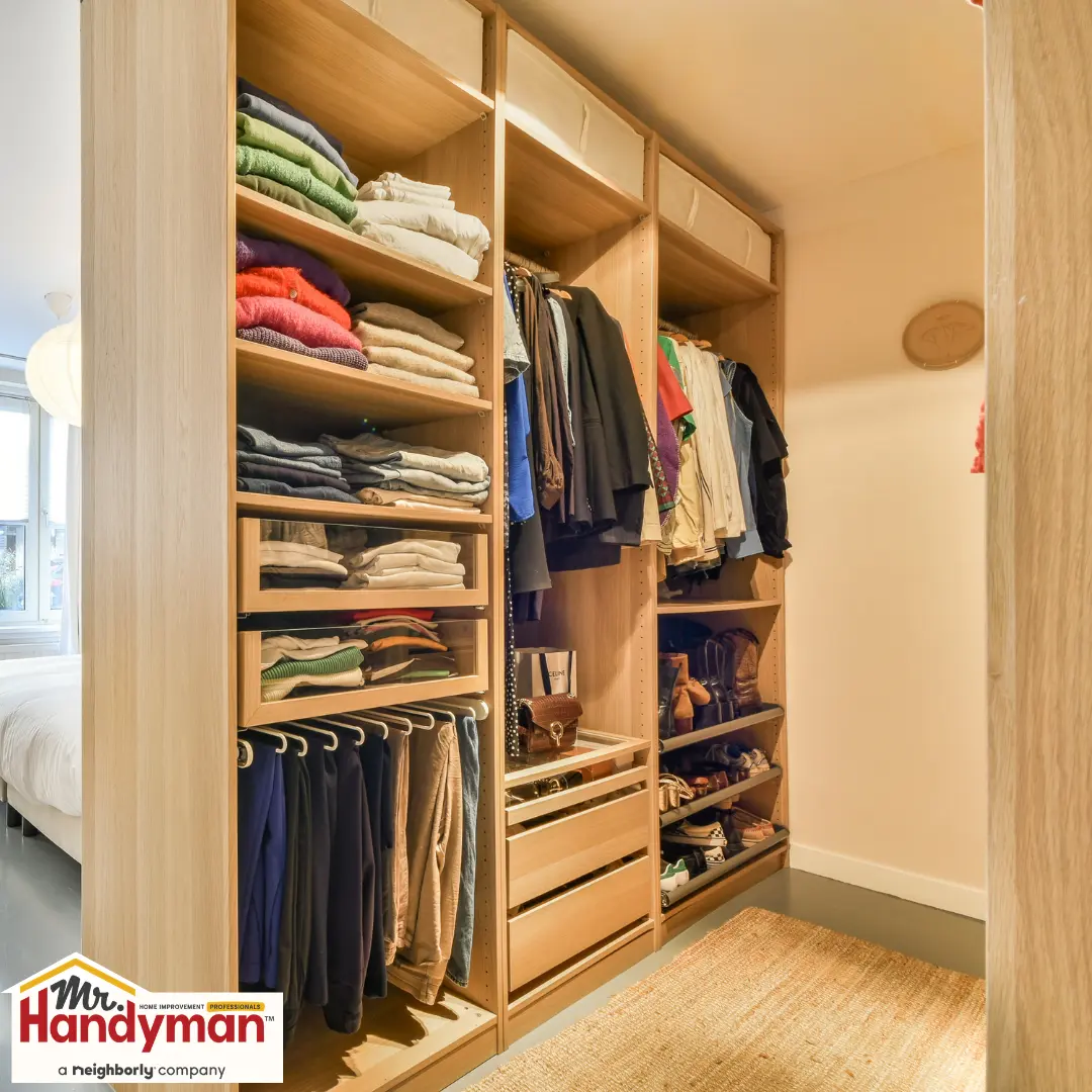Organized wooden shelves holding folded clothes.