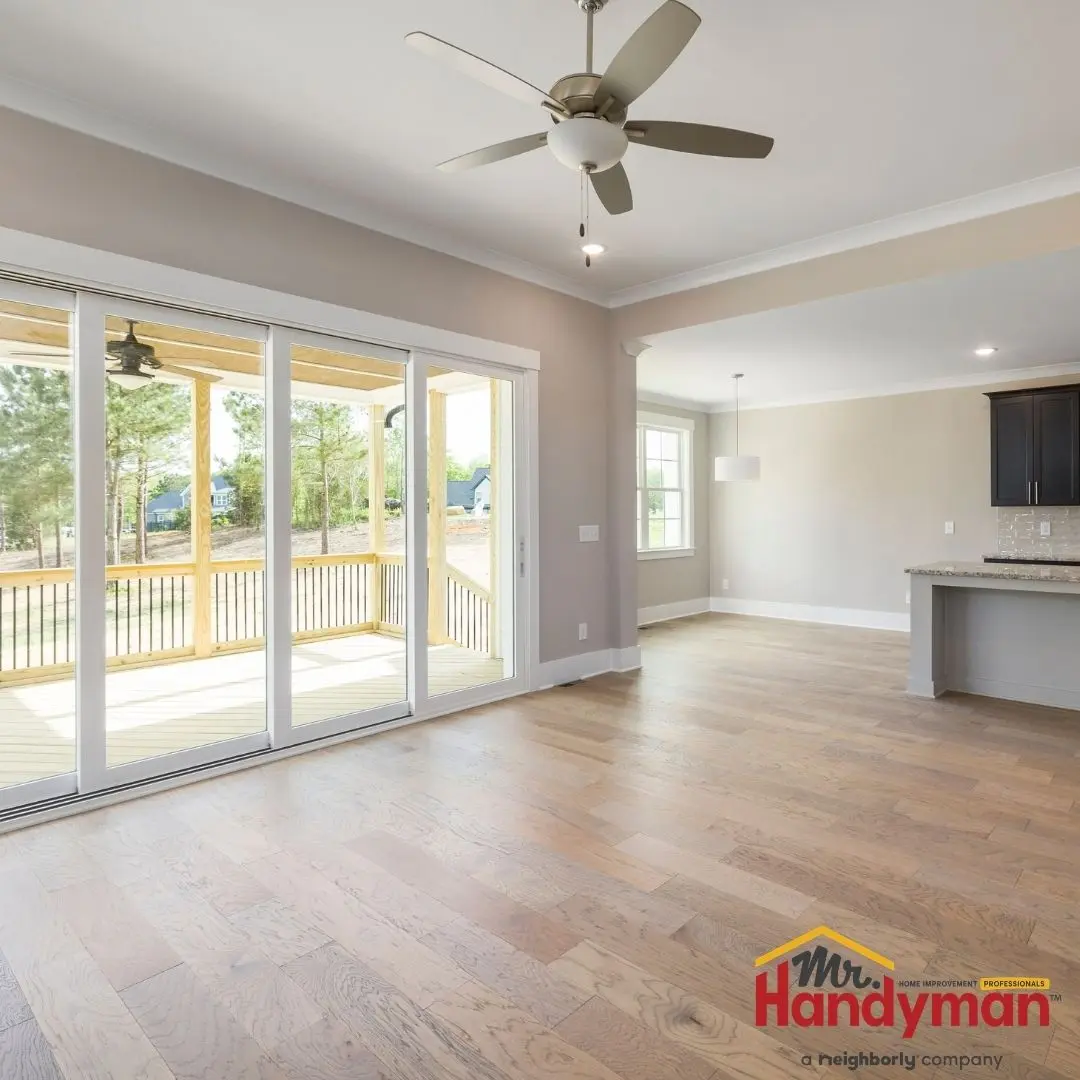 A spacious and clean living room with a hardwood floor.