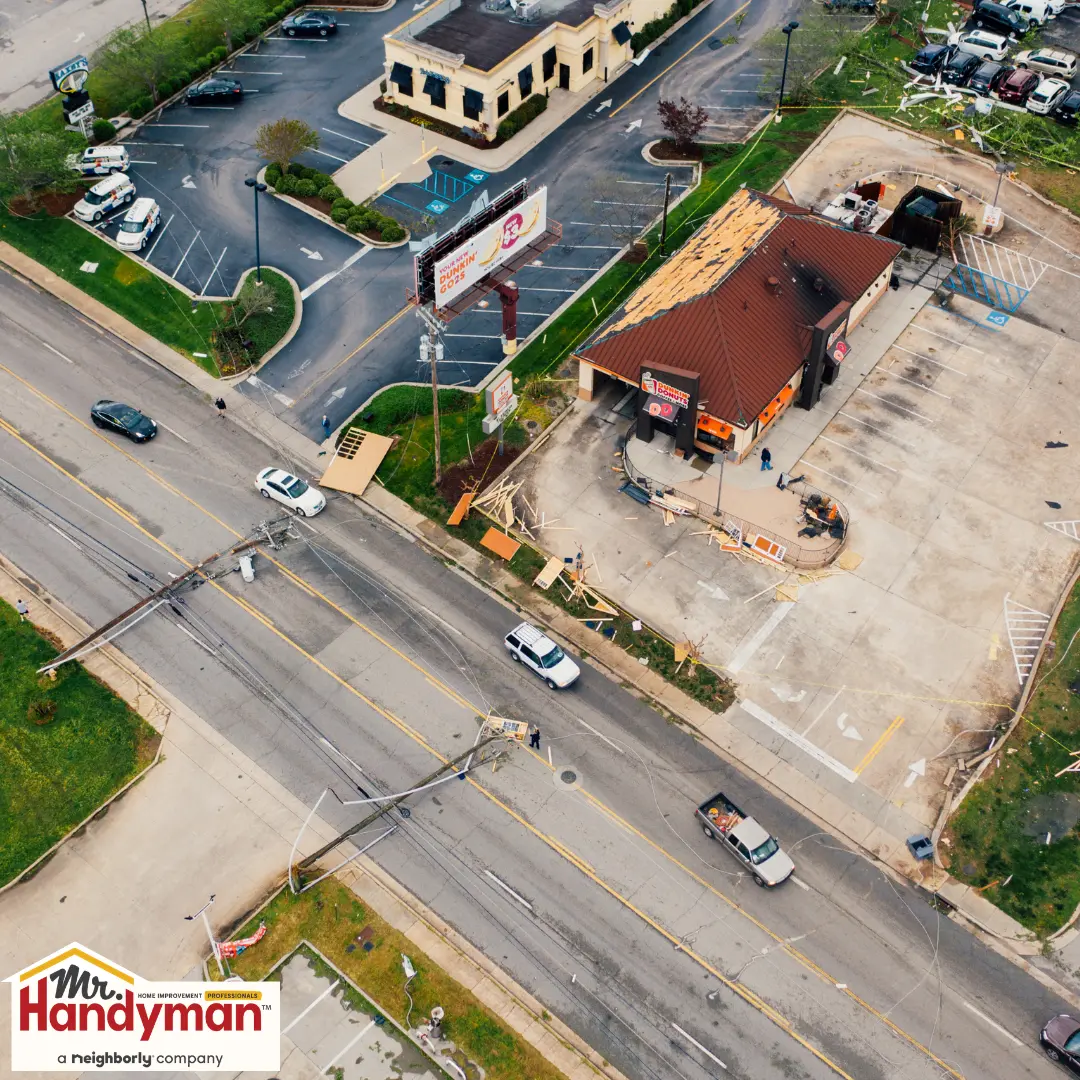 An aerial view of a storefront showing fire damage on the roof.