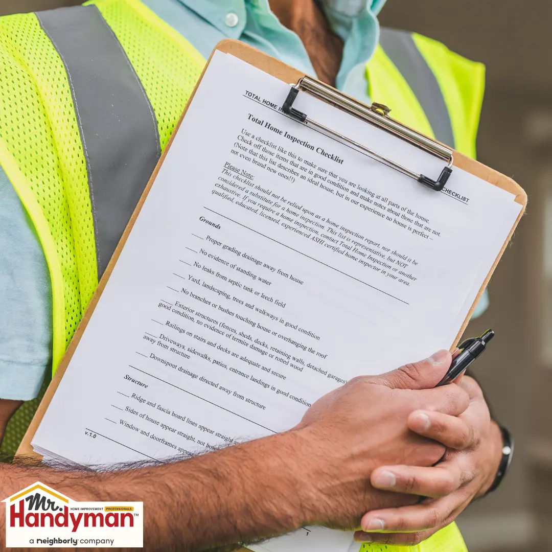 A person in a safety vest holding a clipboard.