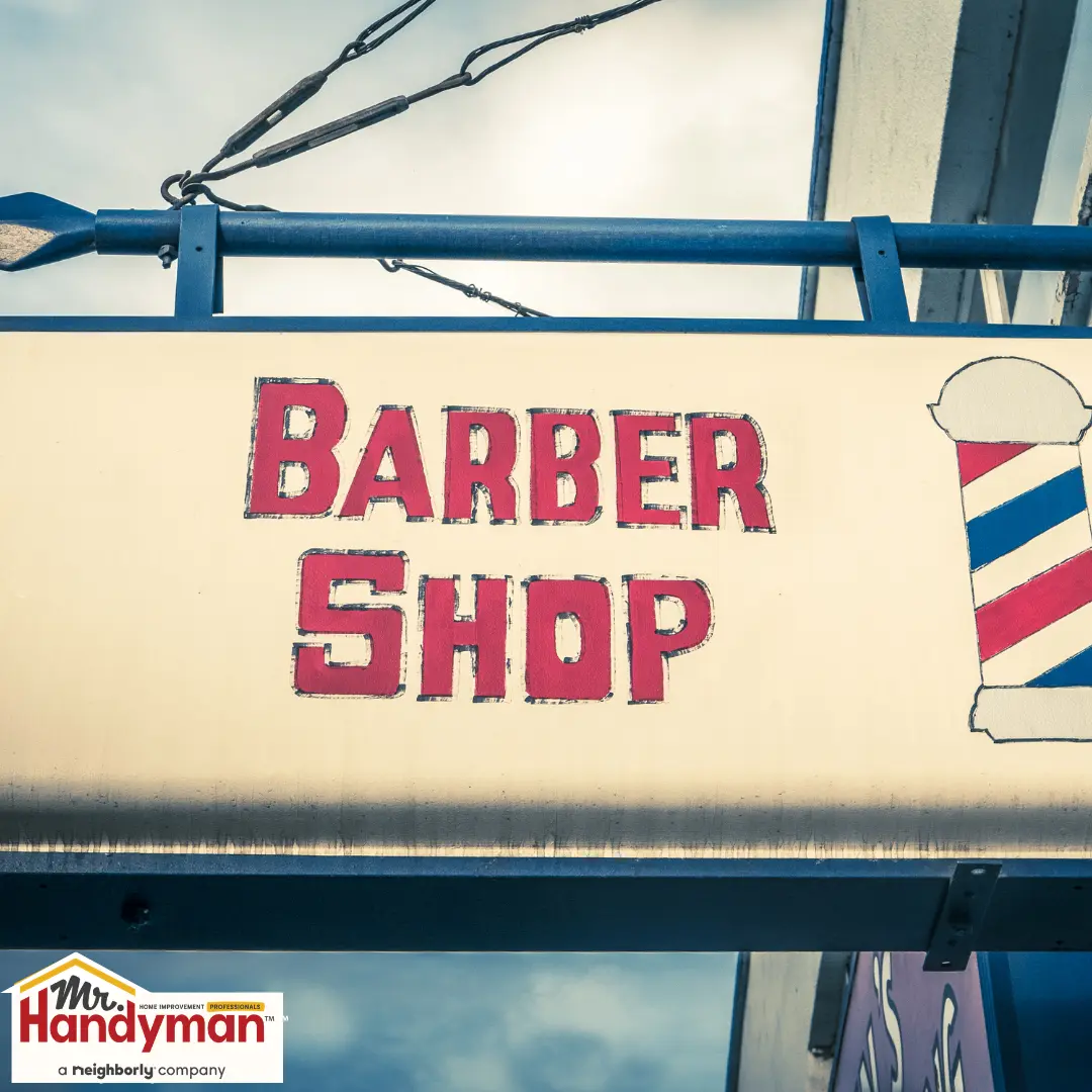 Sign reading &ldquo;Barber shop&rdquo; outside a building.