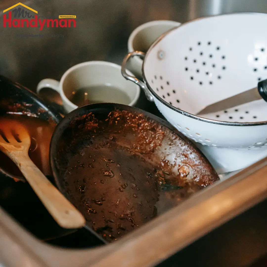dirty dishes piled in a sink-creating a sense of clutter