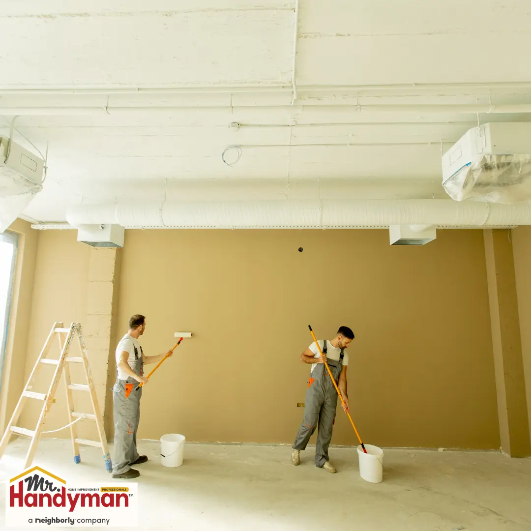 Handyman painting a commercial interior wall to refresh a business space in Cedar Hill Texas